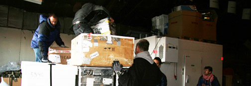 People stacking boxes for loading on the plane