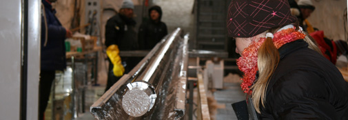 A freshly drilled ice core sticks out from the bottom of the drill. Krissy
is preparing to un-mount the core barrel.